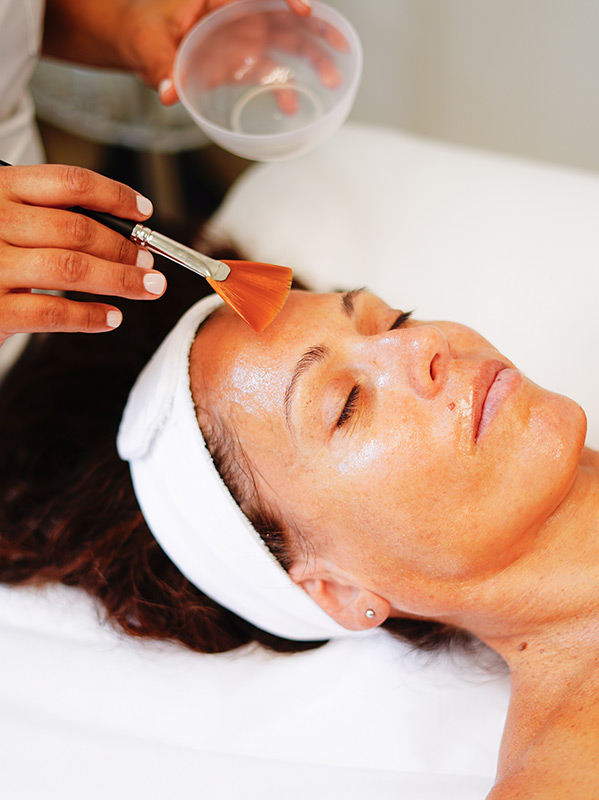 A facial treatment being applied with a brush